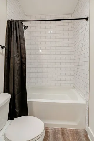 a bathroom with a toilet and a shower