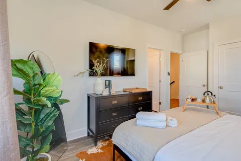 a bedroom with a bed and a flat screen tv