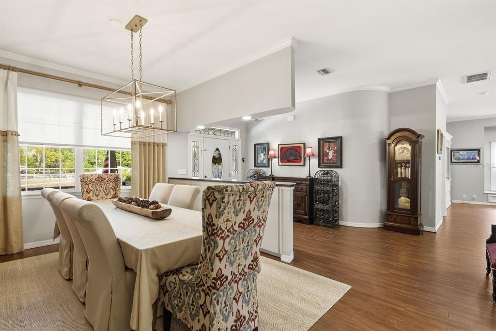 2351 Northeast Coachman Road Clearwater, FL 33765 - Photo 11 of 47 a view of a dining room with furniture window and wooden floor