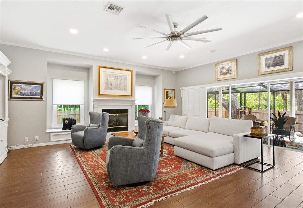 2351 Northeast Coachman Road Clearwater, FL 33765 - Photo 13 of 47 a living room with furniture a large window and a fireplace