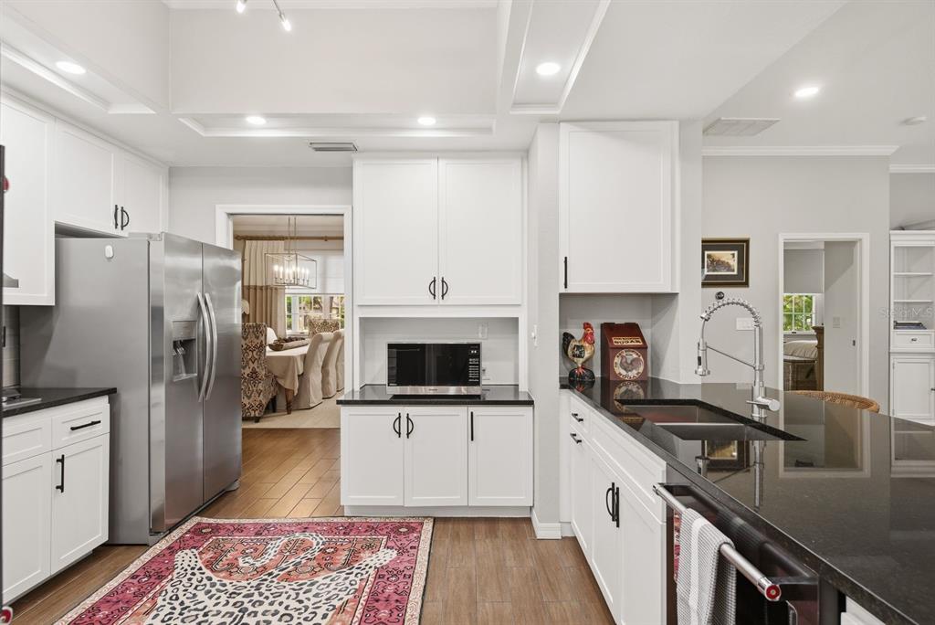 2351 Northeast Coachman Road Clearwater, FL 33765 - Photo 18 of 47 a kitchen with stainless steel appliances a stove refrigerator sink and microwave