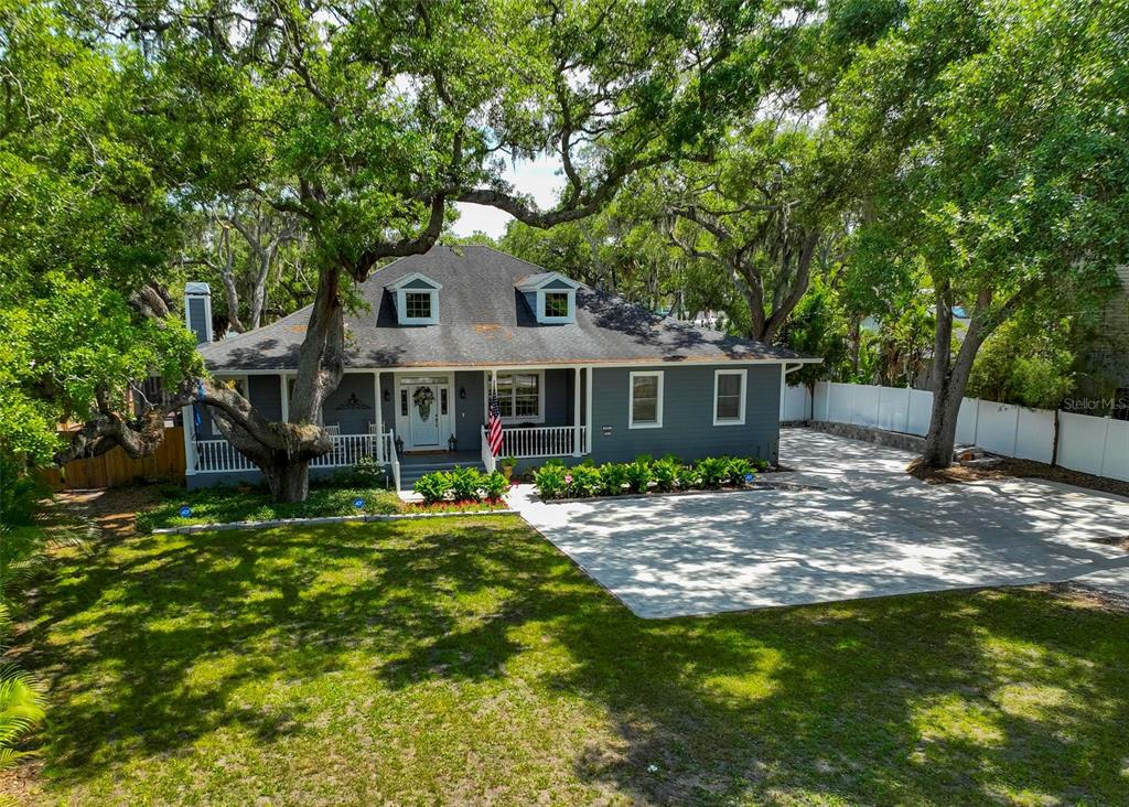 2351 Northeast Coachman Road Clearwater, FL 33765 - Photo 2 of 47 a view of a house with a yard