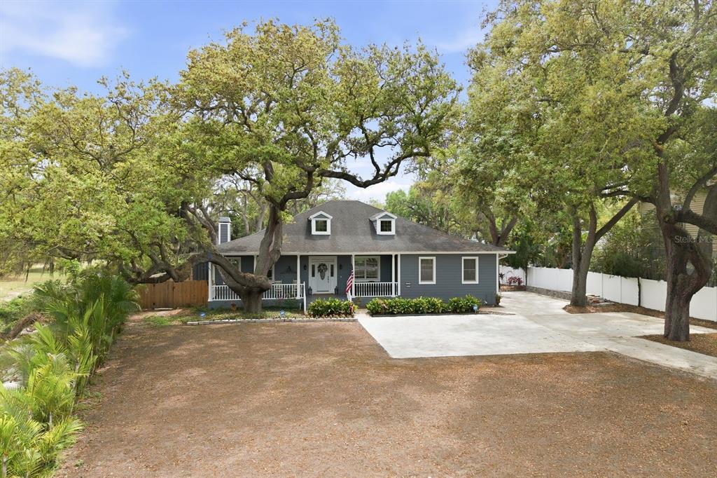 2351 Northeast Coachman Road Clearwater, FL 33765 - Photo 2 of 47 a front view of a house with a garden