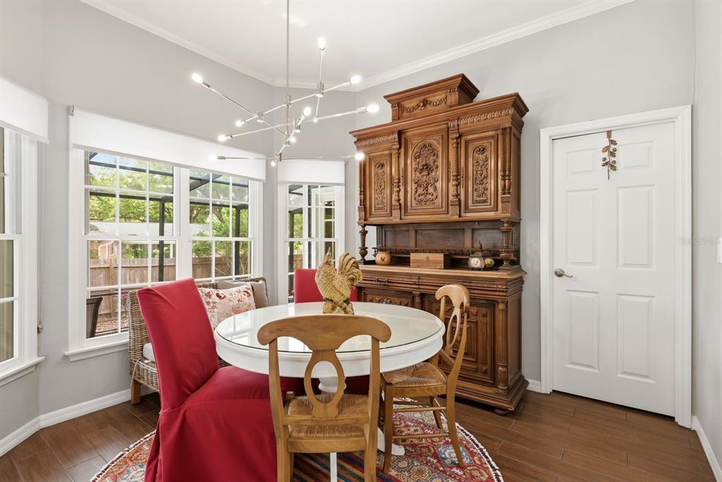 2351 Northeast Coachman Road Clearwater, FL 33765 - Photo 22 of 47 a view of a dining room with furniture window and wooden floor