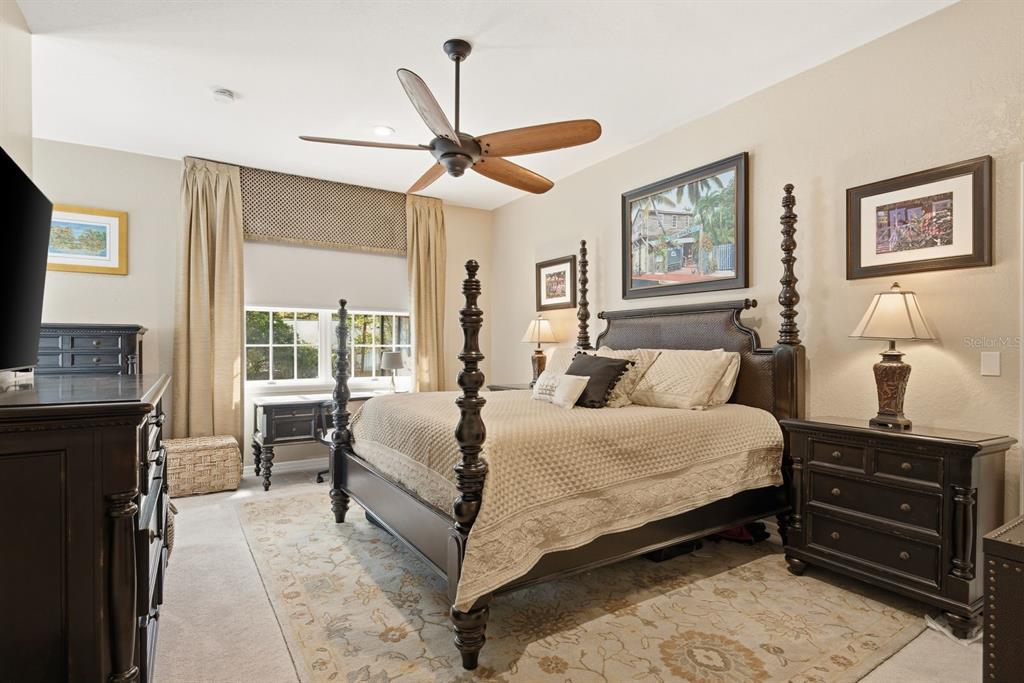 2351 Northeast Coachman Road Clearwater, FL 33765 - Photo 24 of 47 a bedroom with a bed and wooden floor