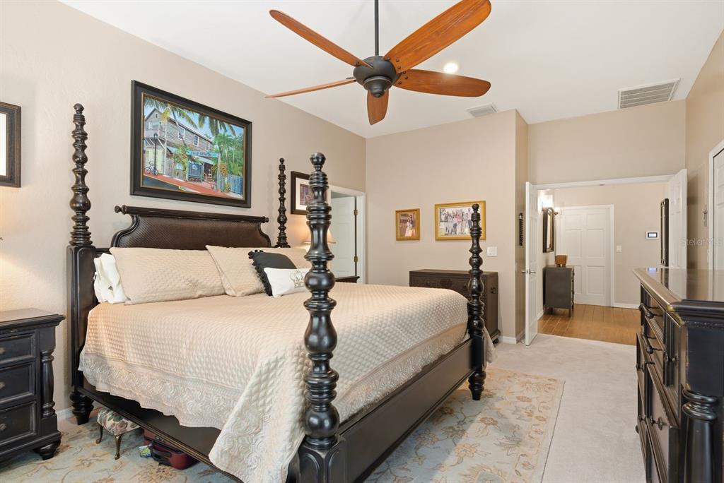 2351 Northeast Coachman Road Clearwater, FL 33765 - Photo 25 of 47 a bedroom with a bed and a chandelier