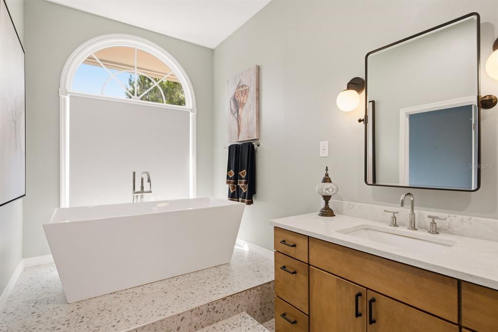 2351 Northeast Coachman Road Clearwater, FL 33765 - Photo 28 of 47 a bathroom with a sink and a mirror