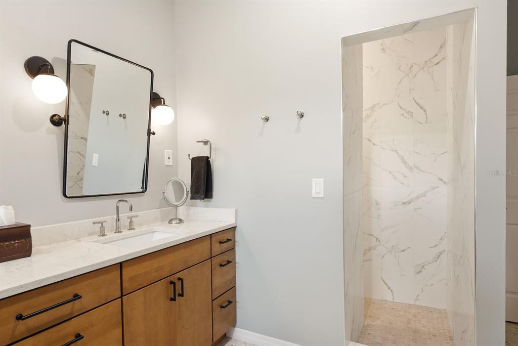 2351 Northeast Coachman Road Clearwater, FL 33765 - Photo 29 of 47 a bathroom with a double vanity sink mirror and