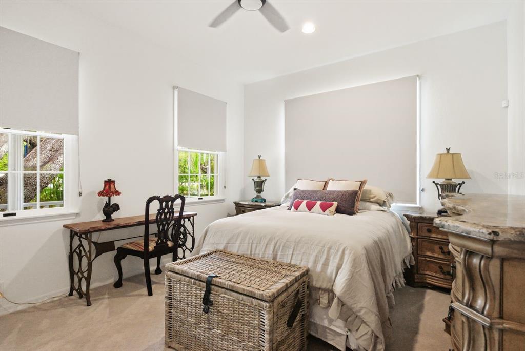 2351 Northeast Coachman Road Clearwater, FL 33765 - Photo 30 of 47 a bedroom with a bed and a table chair