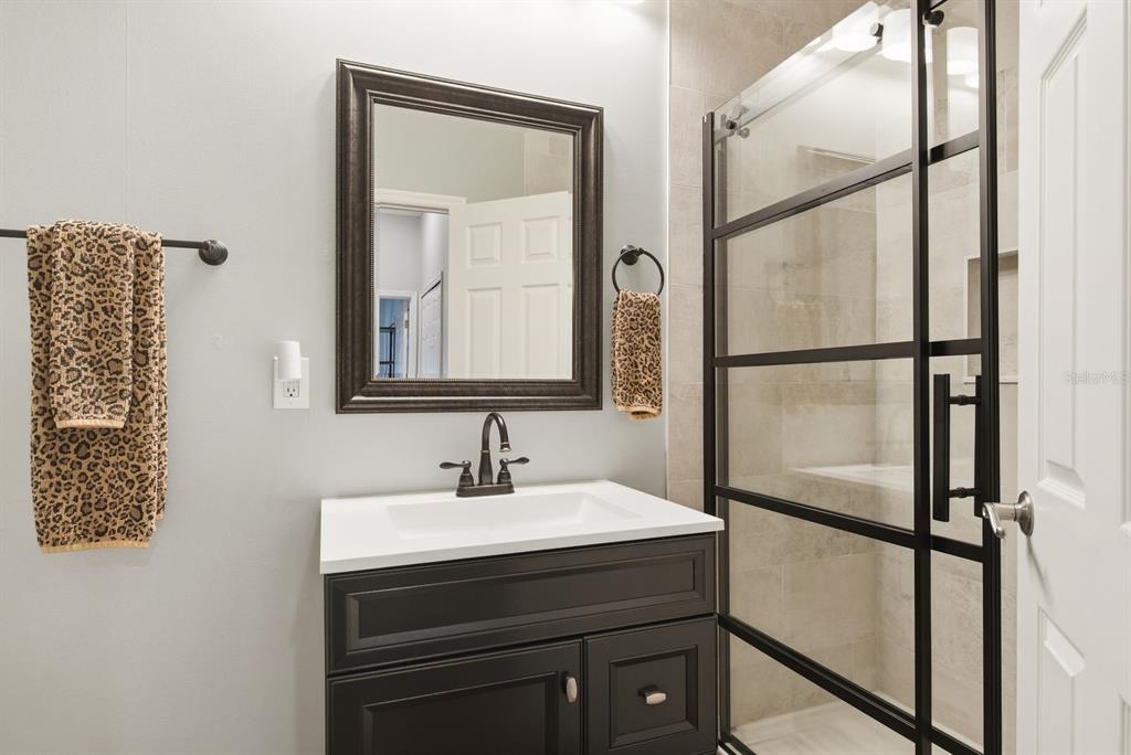 2351 Northeast Coachman Road Clearwater, FL 33765 - Photo 32 of 47 a bathroom with a sink and a mirror