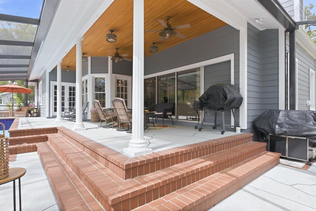 2351 Northeast Coachman Road Clearwater, FL 33765 - Photo 38 of 47 a swimming pool with outdoor seating and yard