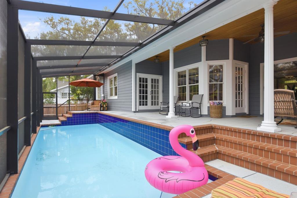 2351 Northeast Coachman Road Clearwater, FL 33765 - Photo 40 of 47 a swimming pool with outdoor seating