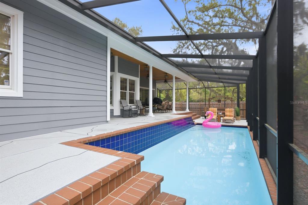 2351 Northeast Coachman Road Clearwater, FL 33765 - Photo 43 of 47 a view of an empty room with a floor to ceiling window and a chandelier