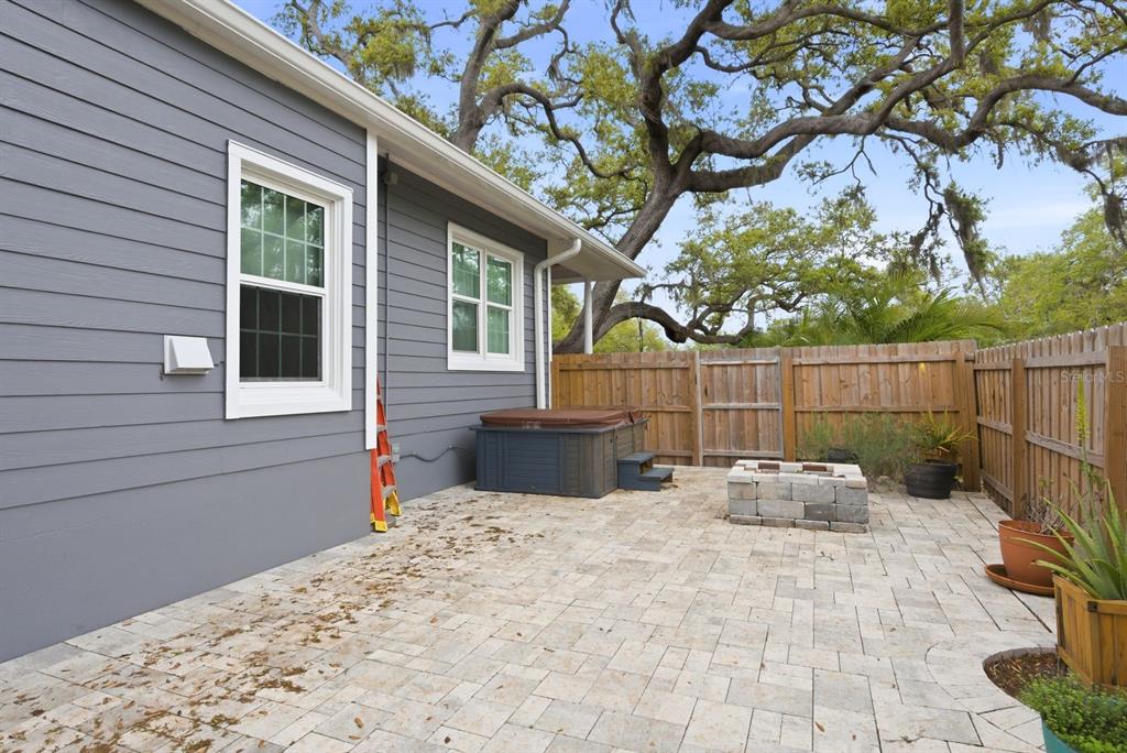 2351 Northeast Coachman Road Clearwater, FL 33765 - Photo 45 of 47 a view of a backyard with a large tree and wooden fence