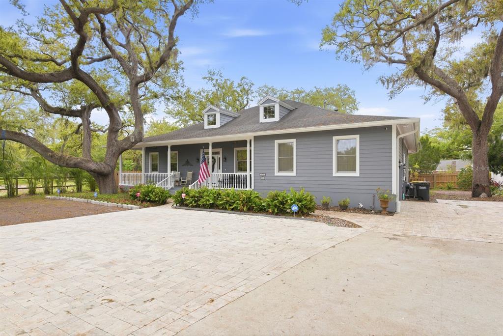 2351 Northeast Coachman Road Clearwater, FL 33765 - Photo 5 of 47 a front view of a house with a yard and garage