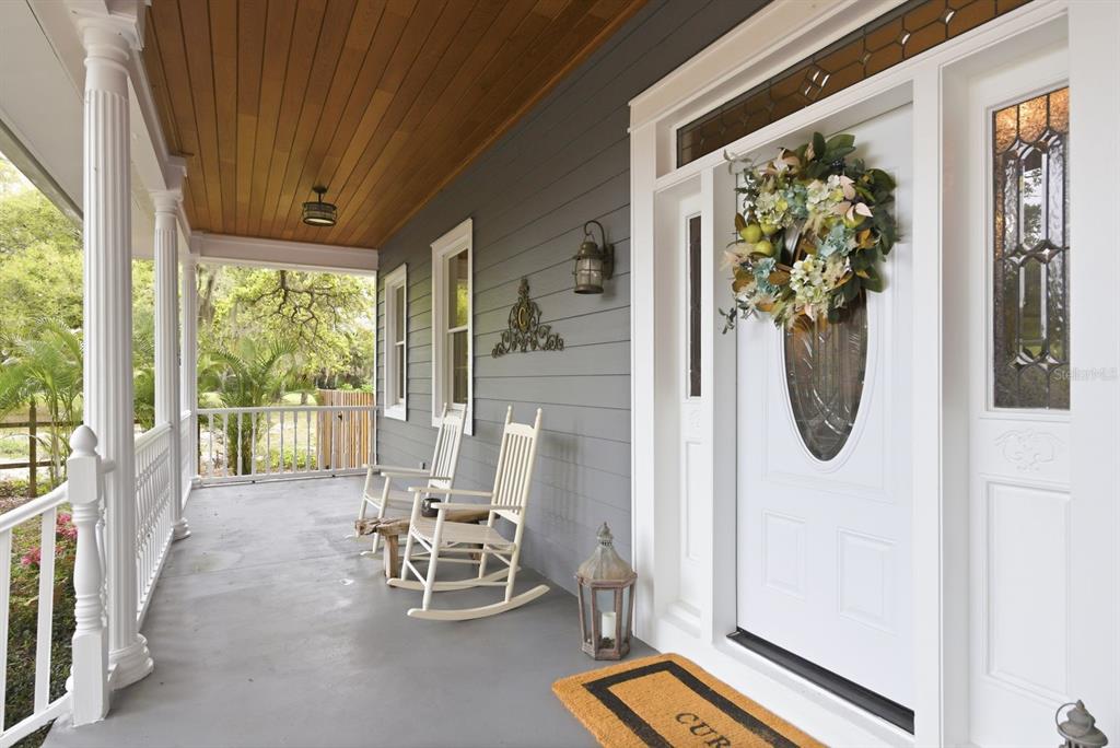 2351 Northeast Coachman Road Clearwater, FL 33765 - Photo 6 of 47 a dining room with furniture and a floor to ceiling window