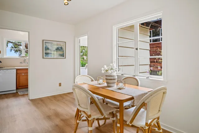 a view of a dining room with furniture and window