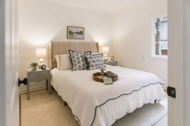 a bedroom with a bed and a night stand