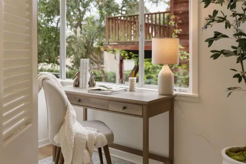 a dining room with furniture and window