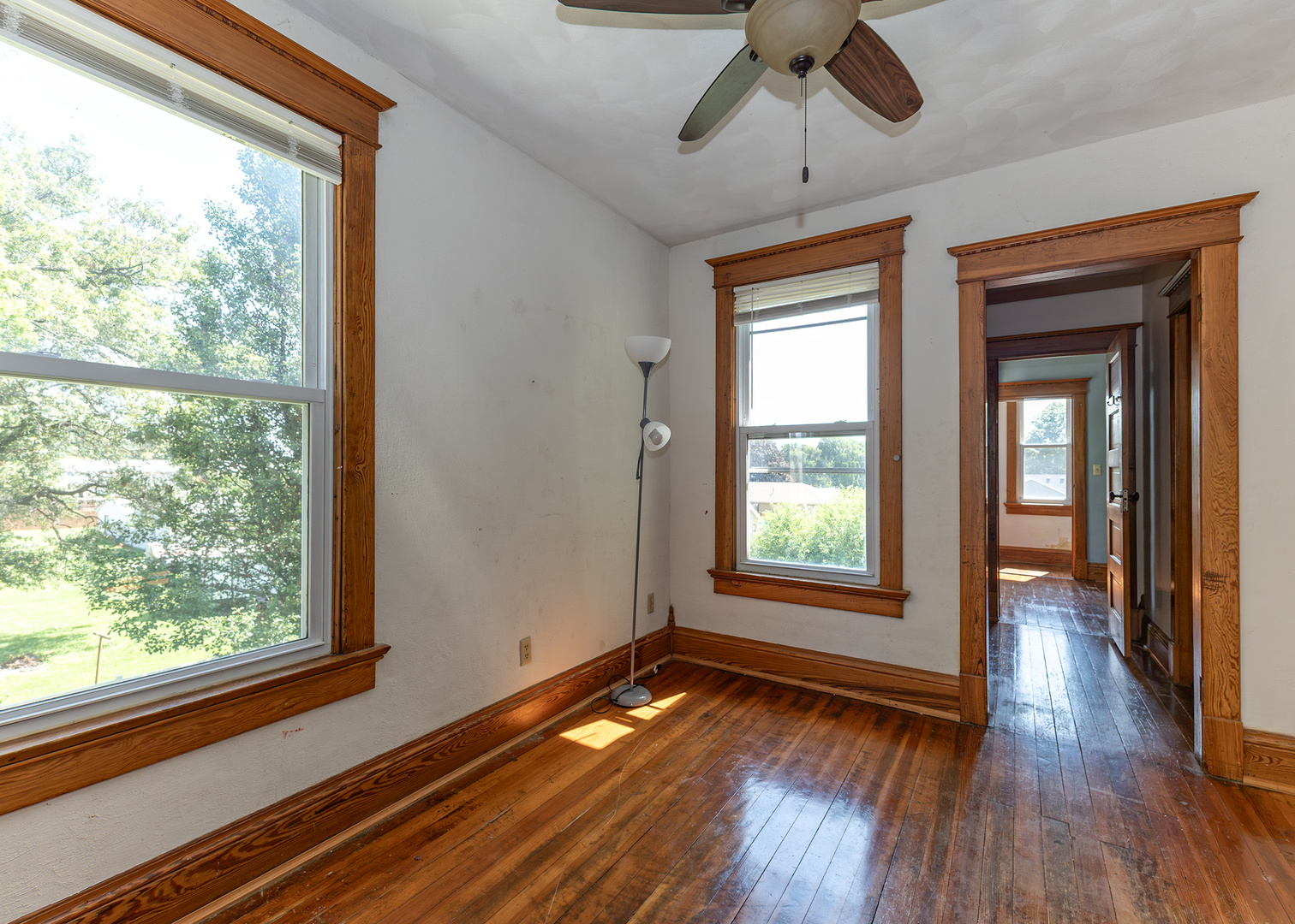112 South State Street Atkinson, IL 61235 - Photo 19 of 24 a view of empty room with wooden floor and fan