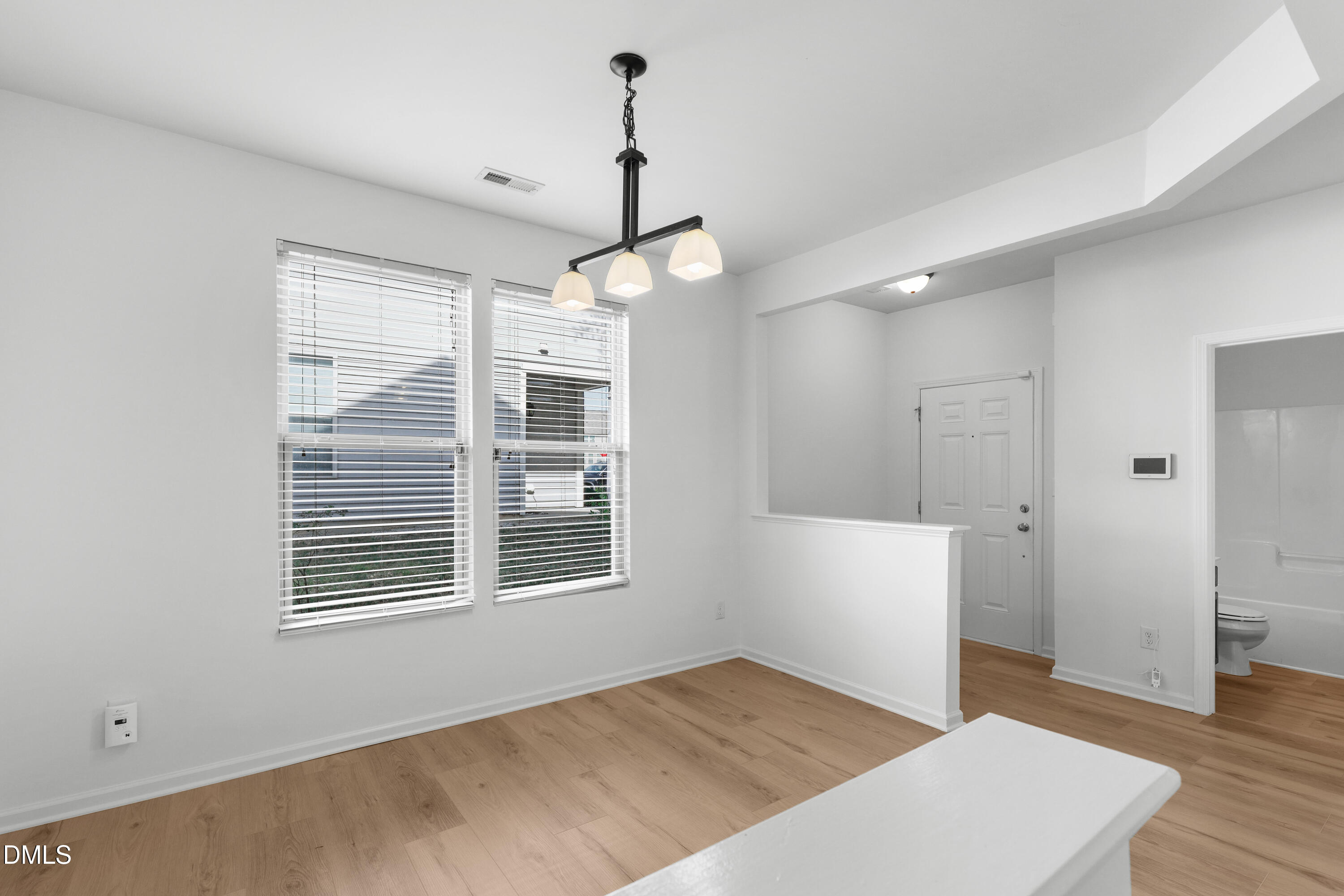 4400 Hillsgrove Road Wake Forest, NC 27587 - Photo 4 of 49 a view of an empty room with wooden floor and a window