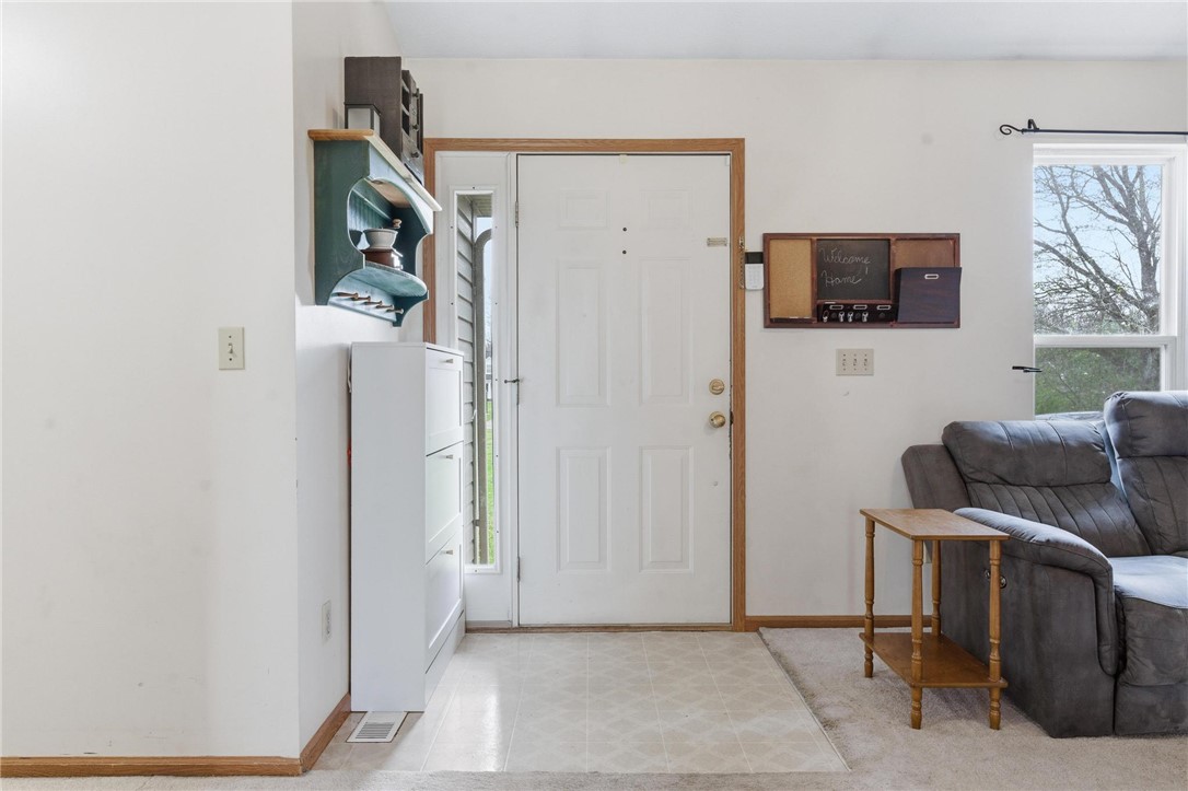 8747 Waynes Way Blanchester, OH 45107 - Photo 3 of 40 The bright entry welcomes you into the inviting home, featuring durable flooring and an adjacent window.