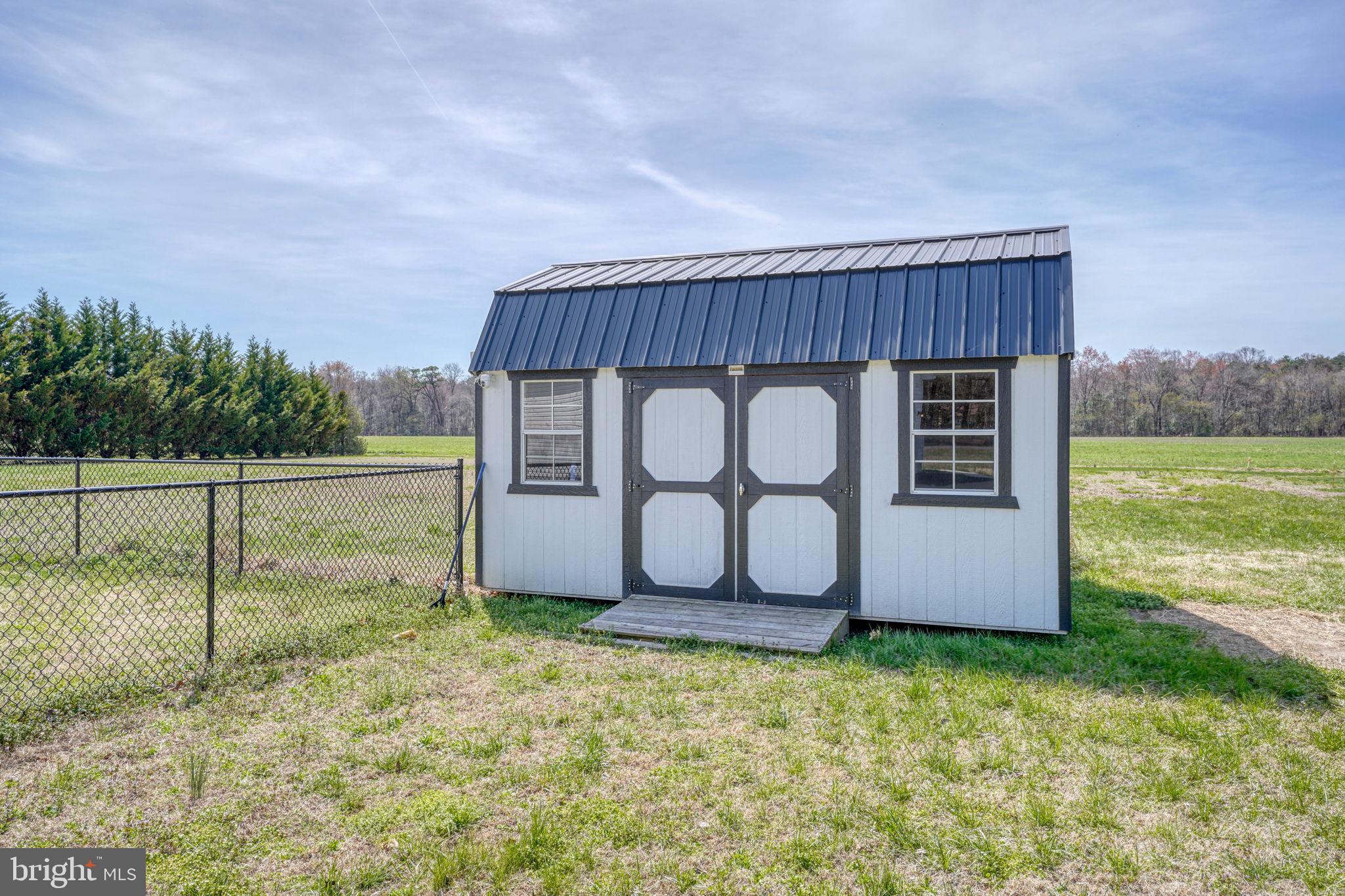 12448 Deer Forest Road Bridgeville, DE 19933 - Photo 12 of 44 Charming shed in a serene landscape.