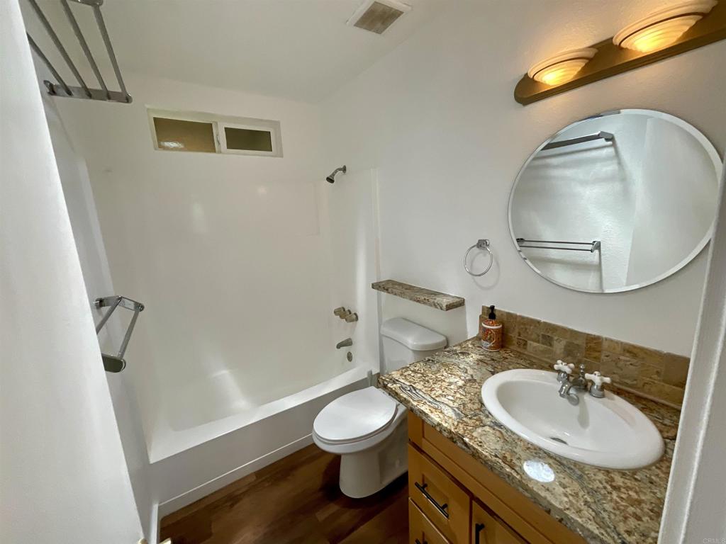 38281 Western Hills Road Anza, CA 92539 - Photo 16 of 75 a bathroom with a granite countertop sink toilet a mirror and vanity