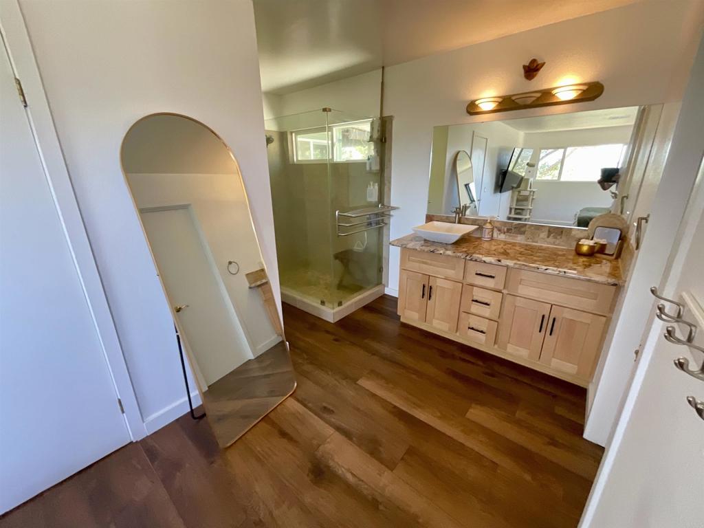 38281 Western Hills Road Anza, CA 92539 - Photo 20 of 75 a bathroom with a granite countertop sink a mirror and a shower