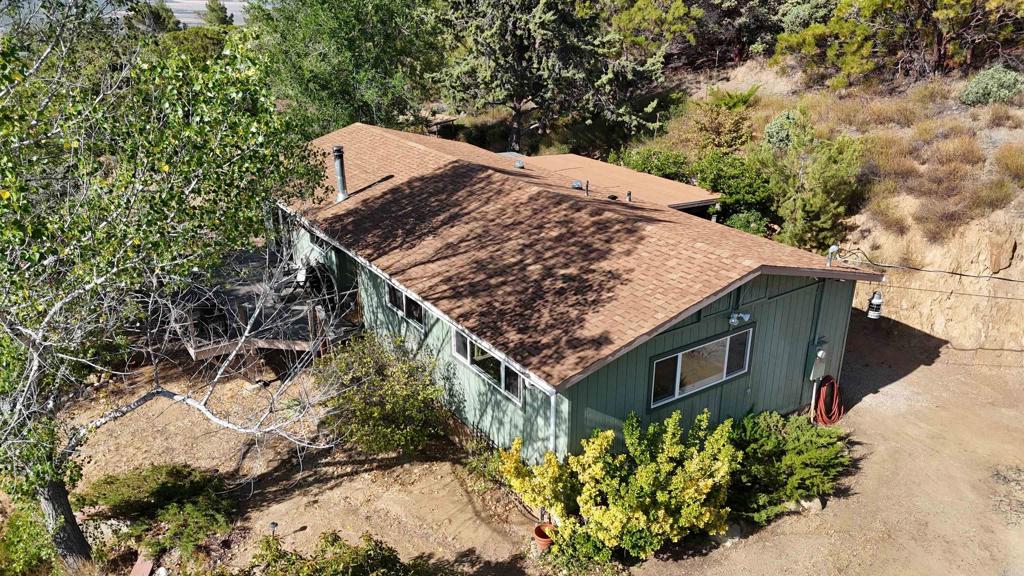 38281 Western Hills Road Anza, CA 92539 - Photo 70 of 75 a view of a wooden house with a yard and potted plants
