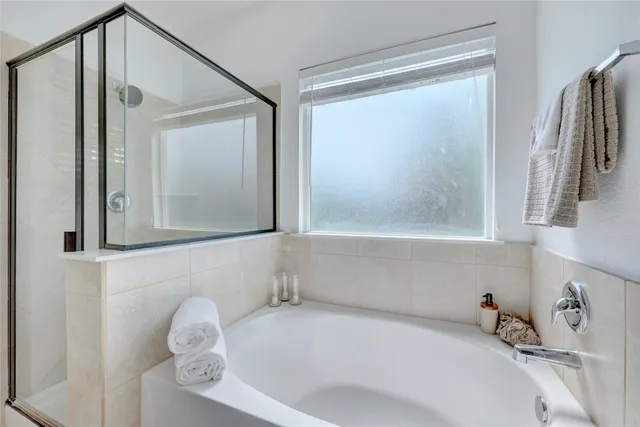 a bathroom with a tub and a sink