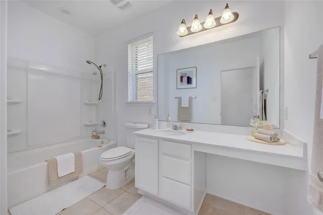 a bathroom with a double vanity sink mirror and toilet