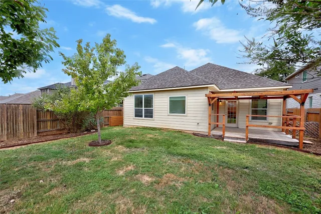 a backyard of a house with table and chairs
