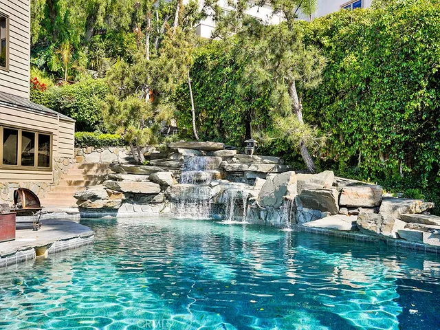 a view of a lake with lots of trees and boats