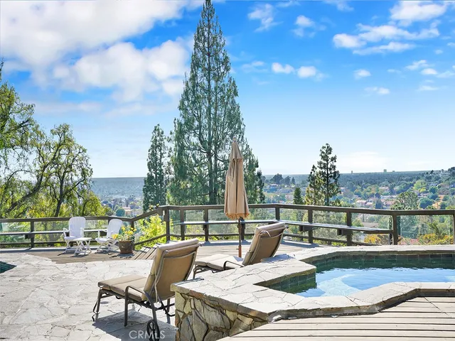 a view of swimming pool with outdoor seating and plants