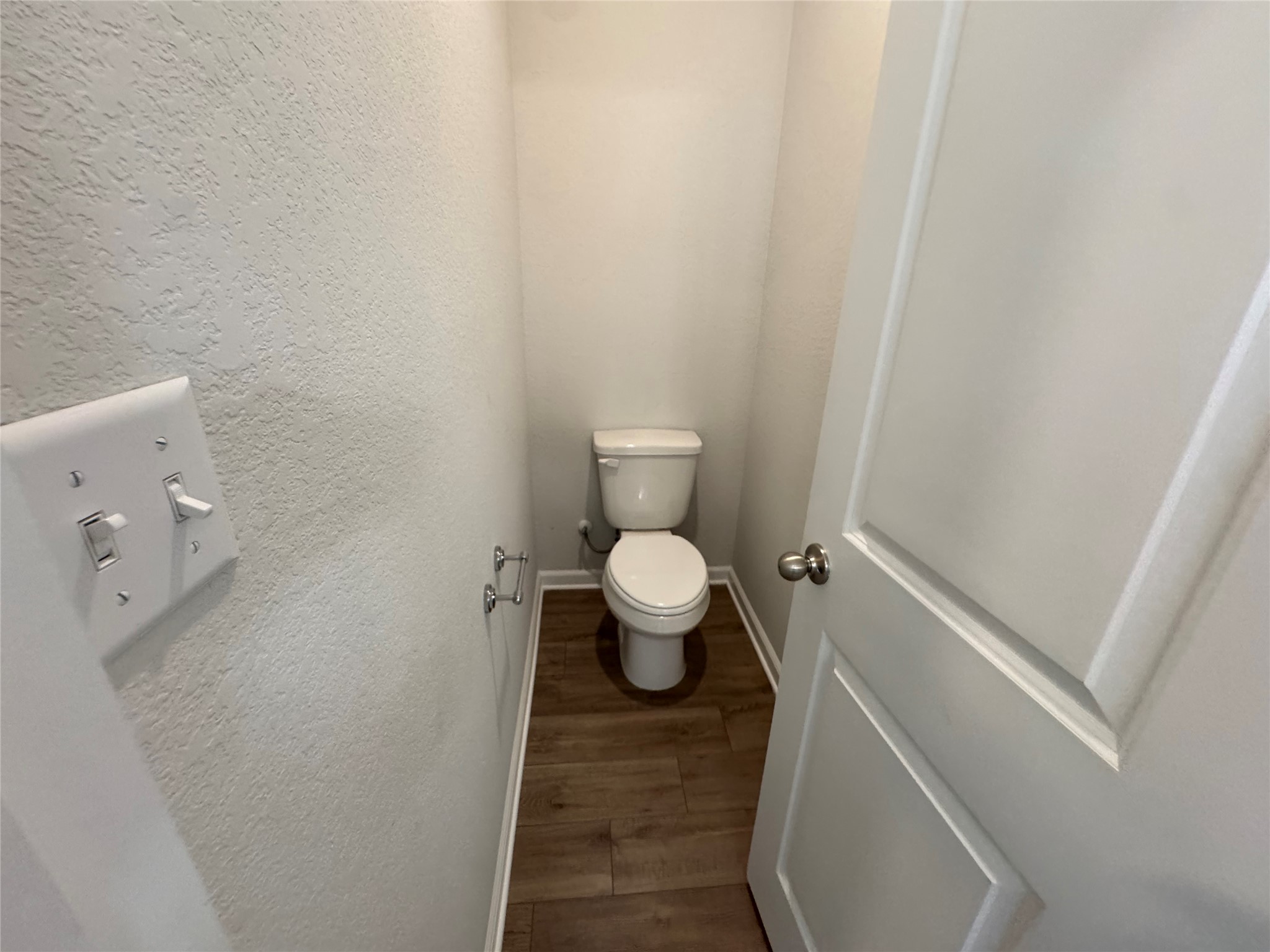 3000 Chisholm Trail Road, Unit 103 Round Rock, TX 78681 - Photo 21 of 32 Bathroom featuring a textured wall and dark wood-type flooring