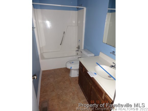 599 Moriston Road Fayetteville, NC 28314 - Photo 6 of 8 a bathroom with a sink and a mirror