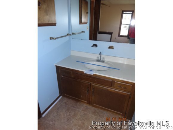 599 Moriston Road Fayetteville, NC 28314 - Photo 7 of 8 a bathroom with a sink and a mirror