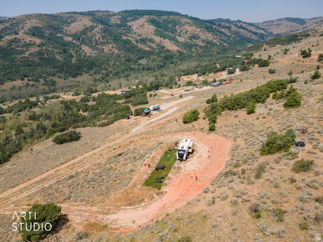 3190 Spring Way, Unit 417 Huntsville, UT 84317 - Photo 18 of 33 Expansive land parcel featuring natural topography, scattered trees, and a distant mountainous backdrop
