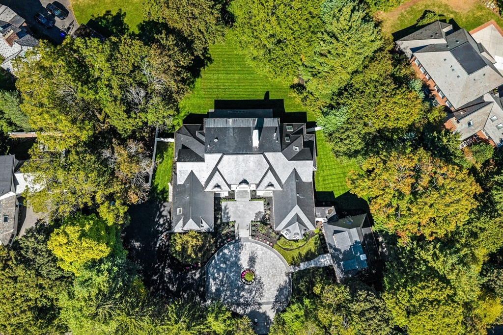 an aerial view of a house with a yard and garden