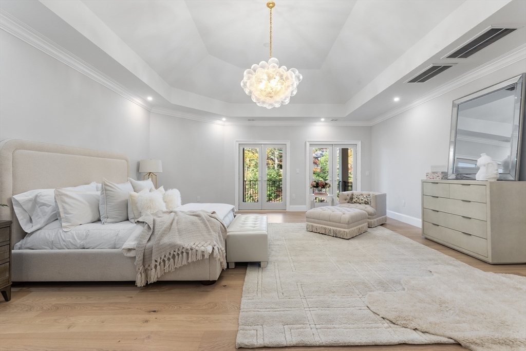 335 Heath Street Brookline, MA 02467 - Photo 26 of 38 a spacious bedroom with a bed and a chandelier