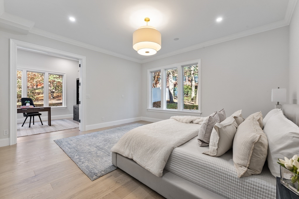 335 Heath Street Brookline, MA 02467 - Photo 29 of 38 a bedroom with a bed and a chandelier