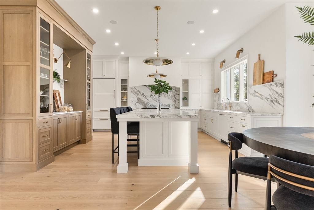 335 Heath Street Brookline, MA 02467 - Photo 6 of 38 a view of kitchen with kitchen island dining table and chairs