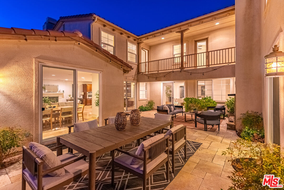3447 Sentinel Court Simi Valley, CA 93065 - Photo 16 of 19 a roof deck with a table and chairs and potted plants