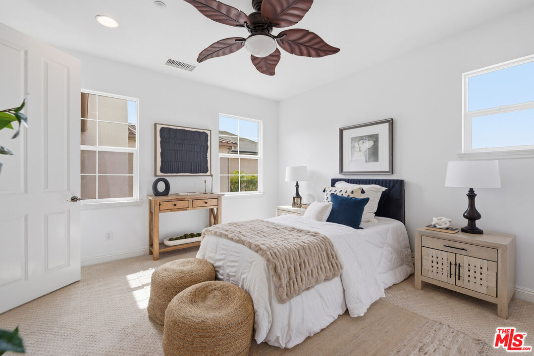 3447 Sentinel Court Simi Valley, CA 93065 - Photo 8 of 19 a bedroom with a bed a couch and dresser with wooden floor
