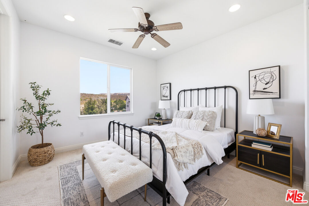 3447 Sentinel Court Simi Valley, CA 93065 - Photo 9 of 19 a bedroom with a bed and a chandelier