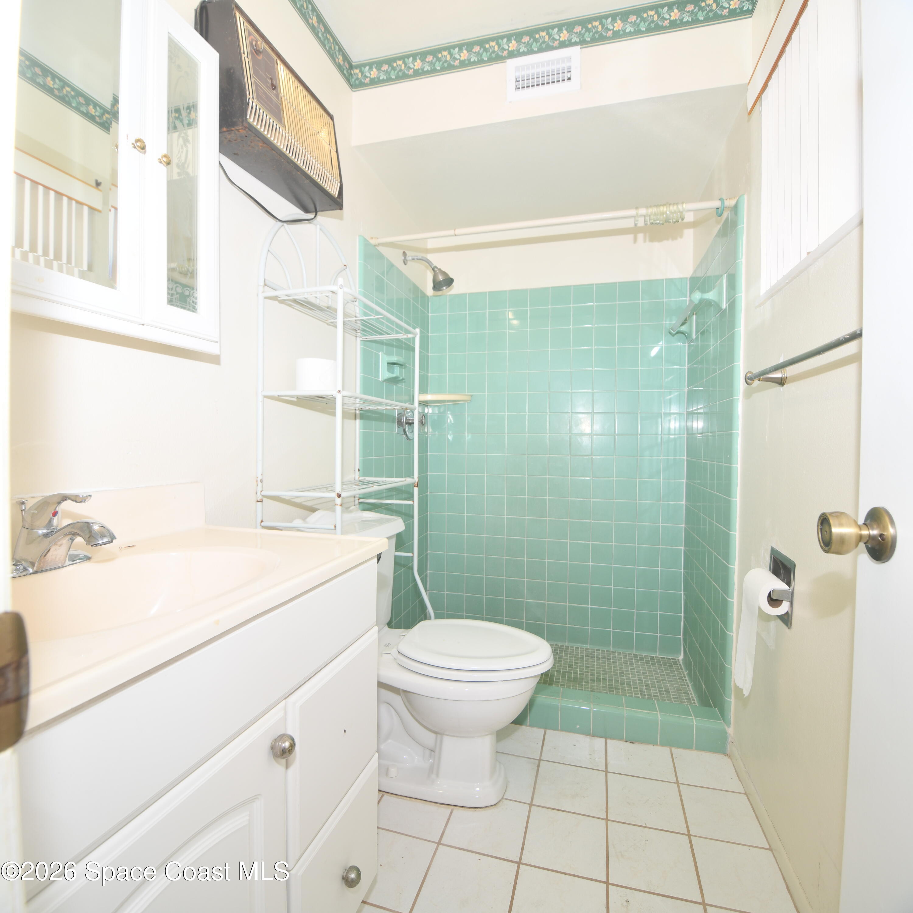 839 Angle Street Northeast Palm Bay, FL 32905 - Photo 14 of 21 a bathroom with a sink a toilet and shower