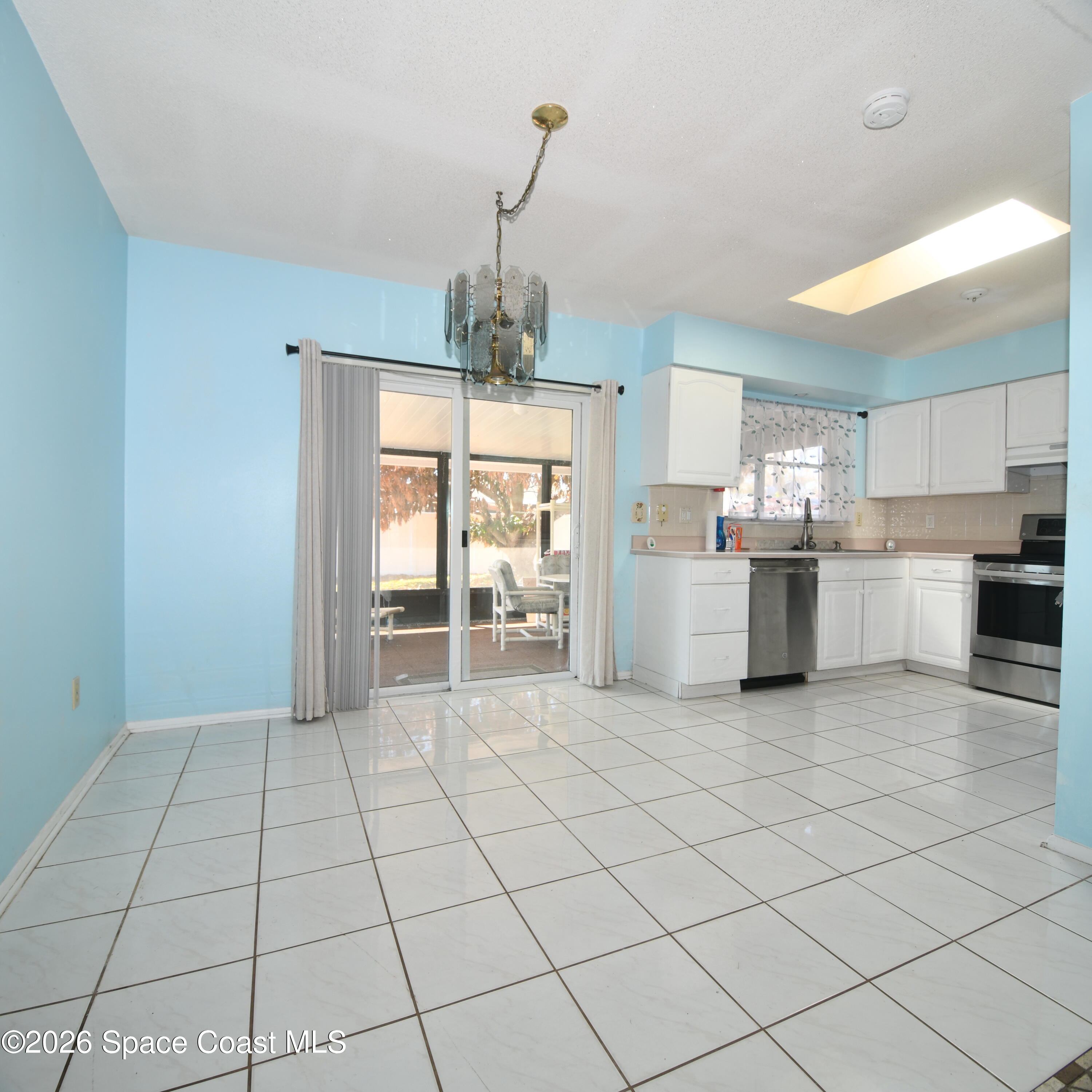 839 Angle Street Northeast Palm Bay, FL 32905 - Photo 4 of 21 a open kitchen with cabinets and stainless steel appliances