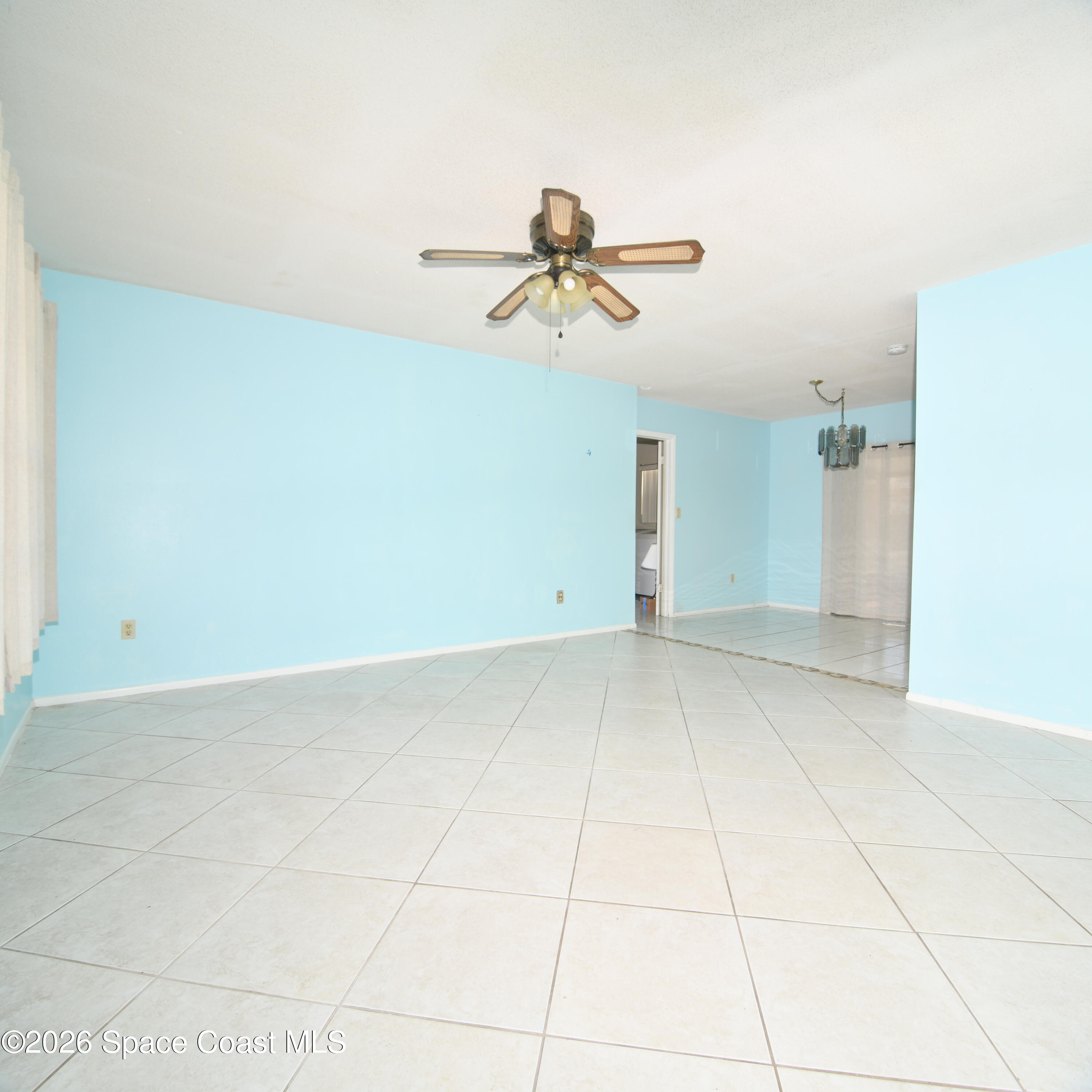 839 Angle Street Northeast Palm Bay, FL 32905 - Photo 7 of 21 a view of a room with wooden floor and ceiling fan