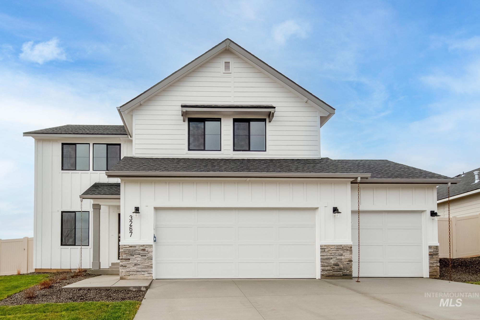 Modern farmhouse with roof with shingles, board and batten siding, and stone siding